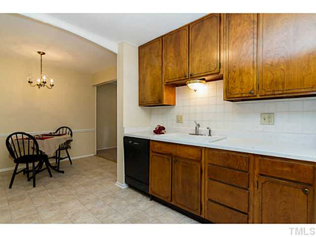 1317 Clermont Road Durham, NC 27713 - Photo 10 of 25 a kitchen with a sink cabinets and chair