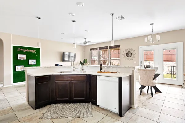a kitchen with granite countertop a stove top oven sink and cabinets