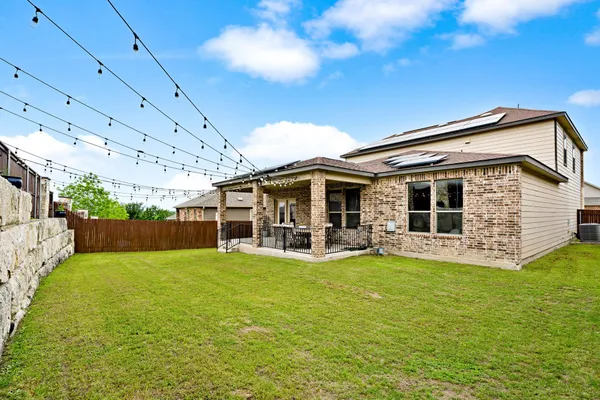 a view of a house with a yard and sitting area