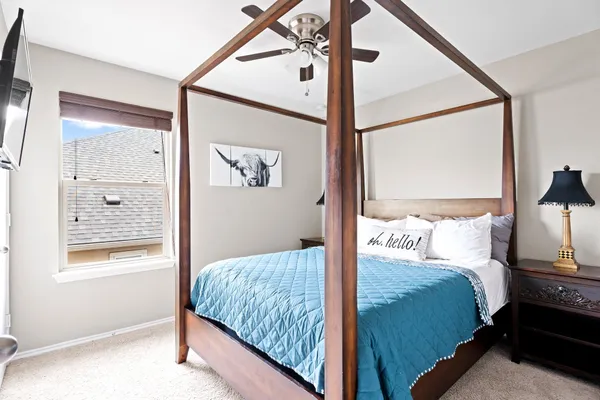 a bedroom with a bed and a window