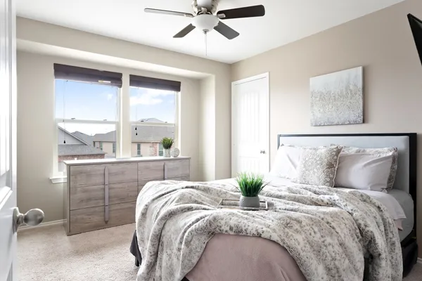 a bedroom with a large bed and a window