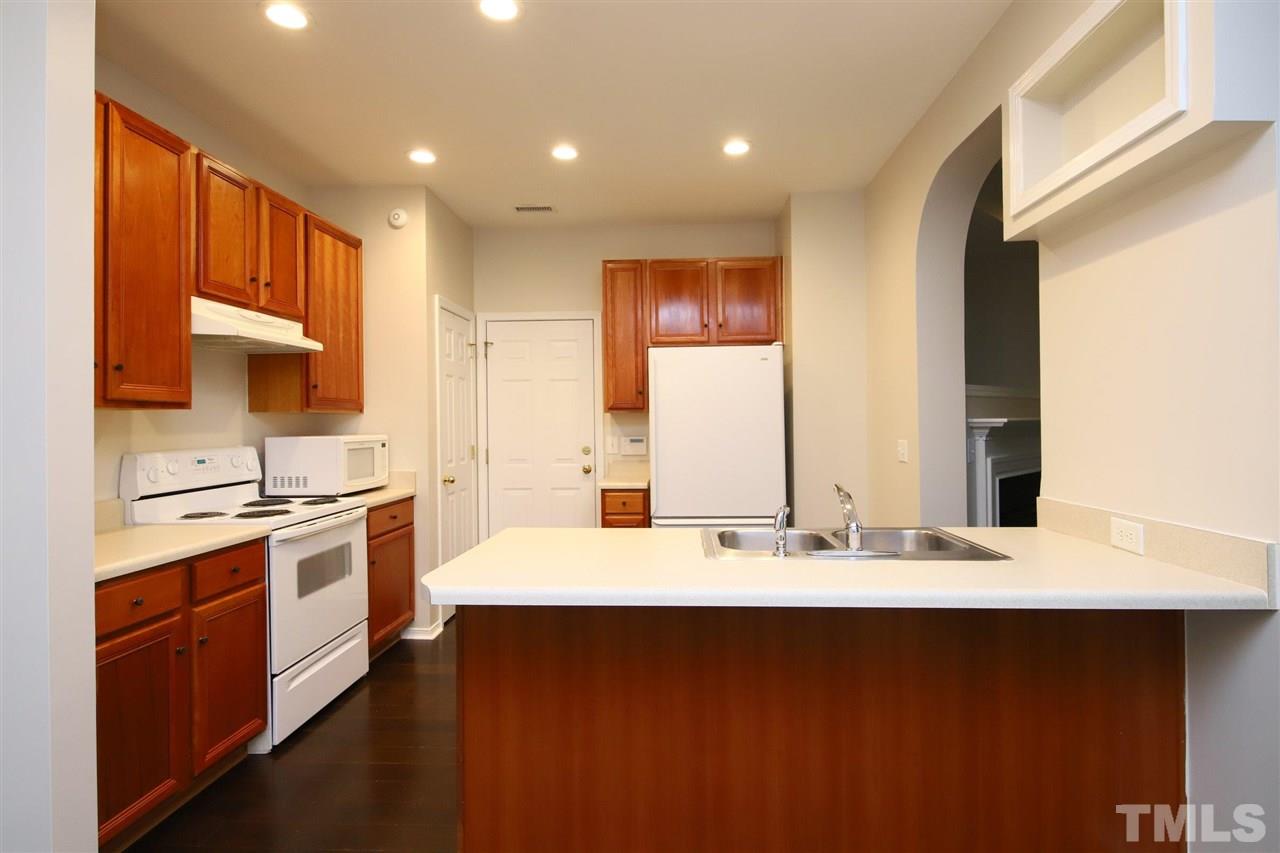 8301 Flat Keystone Drive Raleigh, NC 27613 - Photo 14 of 27 a kitchen with a sink stove and cabinets