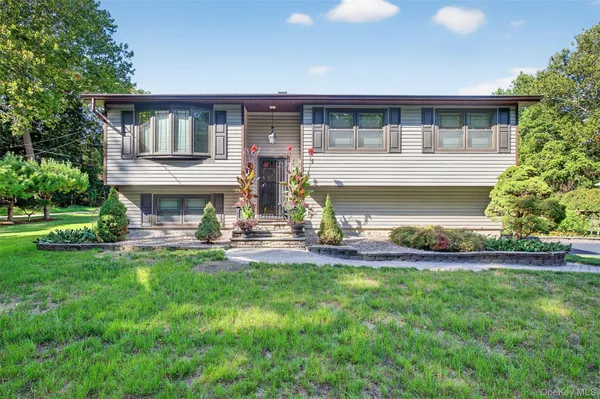 a front view of house with yard and outdoor seating