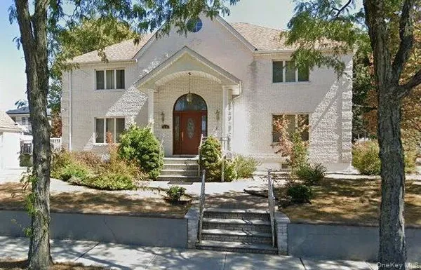 a front view of a house with trees