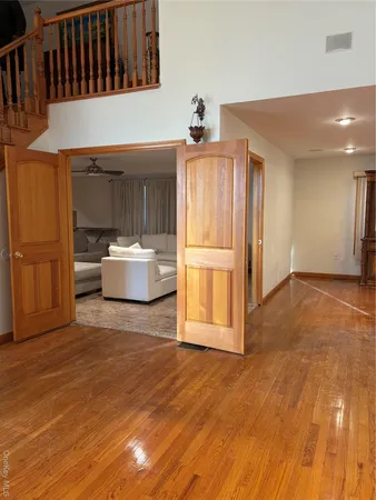 a room with wooden floor and furniture