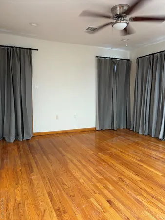 a view of a room with a ceiling fan