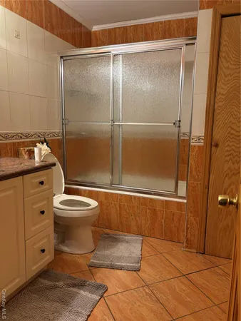 a bathroom with a toilet sink and shower