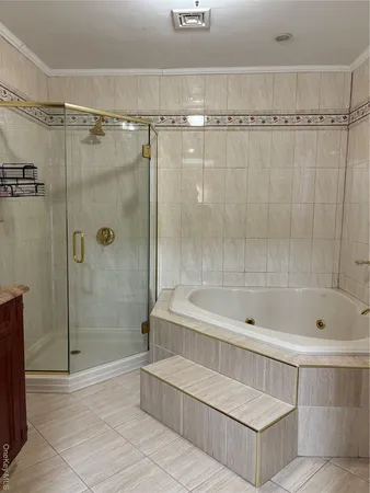 a bathroom with a bathtub a toilet and shower