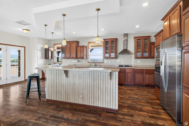 1 Tobe Day Road La Sal, UT 84530 - Photo 7 of 67 Spacious kitchen featuring a central island with beadboard paneling, rich wood-finish flooring, stainless steel appliances, and ample cabinetry