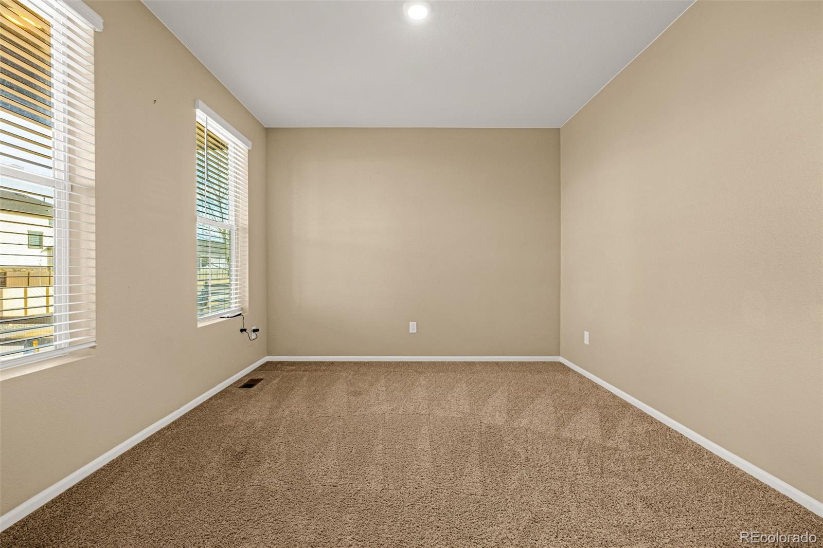 91 South Quantock Street Aurora, CO 80018 - Photo 12 of 45 an empty room with windows