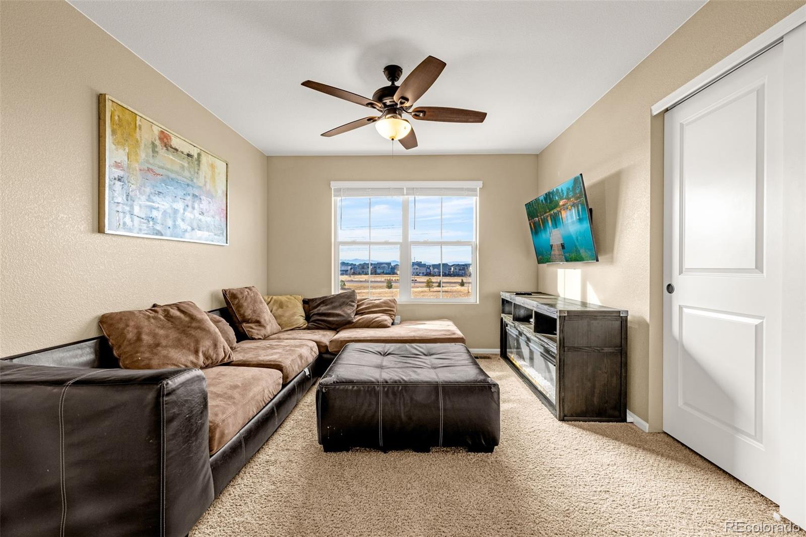 91 South Quantock Street Aurora, CO 80018 - Photo 22 of 45 a living room with furniture and a window