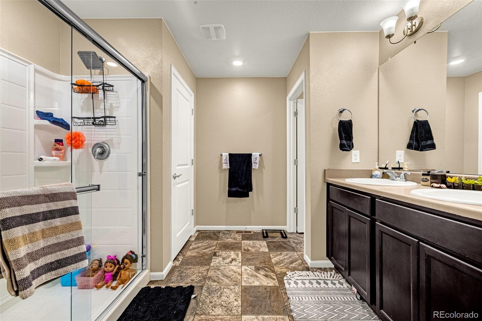 91 South Quantock Street Aurora, CO 80018 - Photo 26 of 45 a bathroom with a sink and a mirror