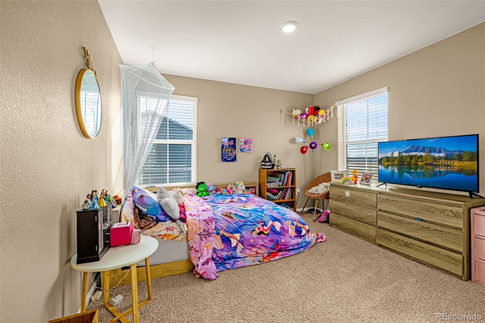 91 South Quantock Street Aurora, CO 80018 - Photo 29 of 45 a living room with furniture and a floor to ceiling window