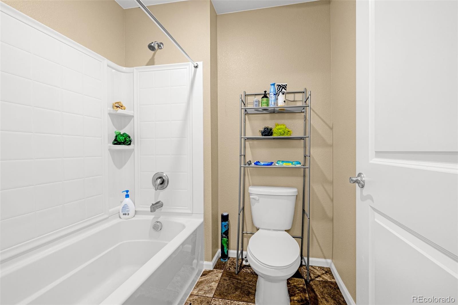 91 South Quantock Street Aurora, CO 80018 - Photo 32 of 45 a bathroom with a sink and toilet