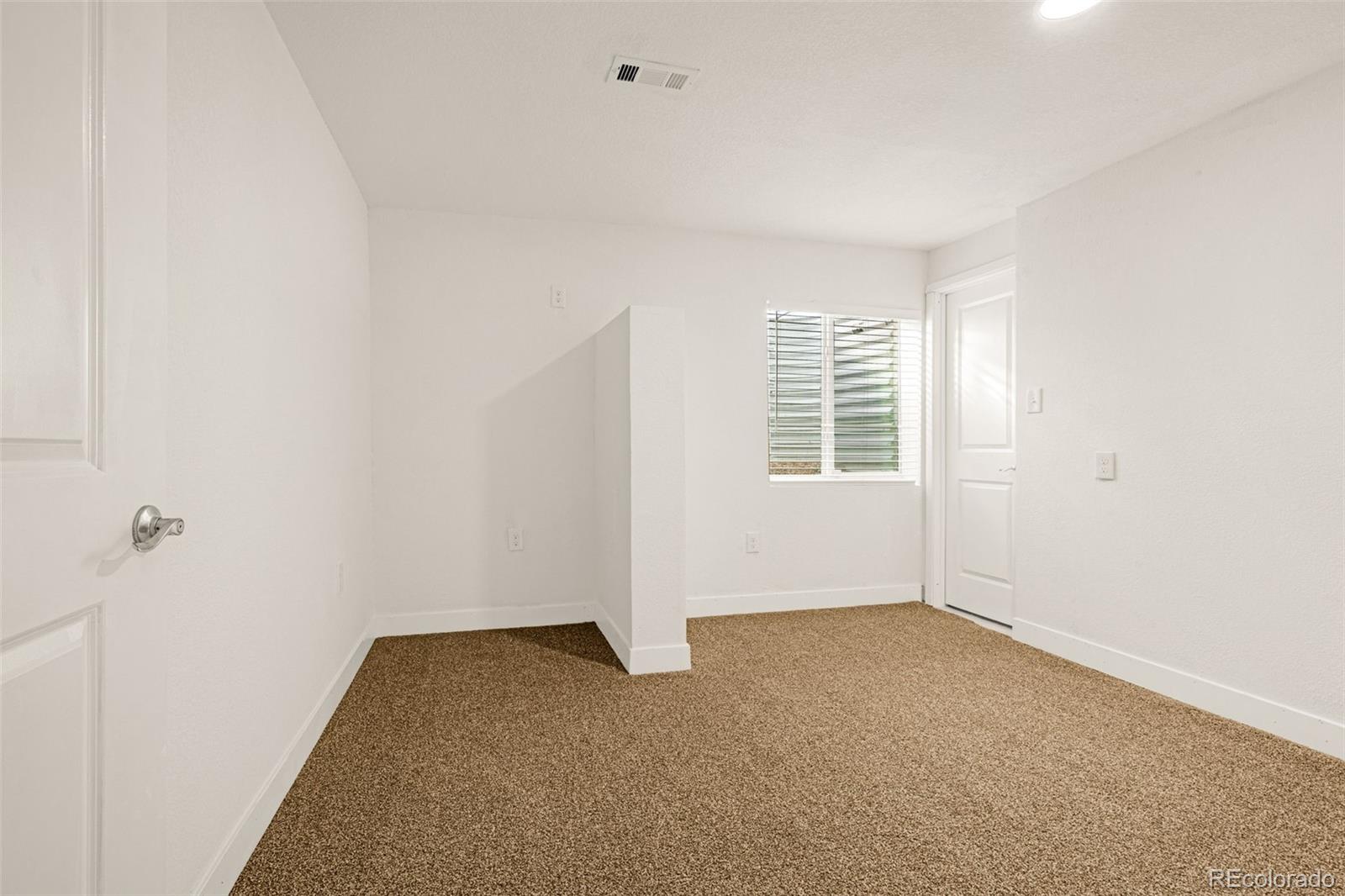 91 South Quantock Street Aurora, CO 80018 - Photo 37 of 45 a view of an empty room with a window