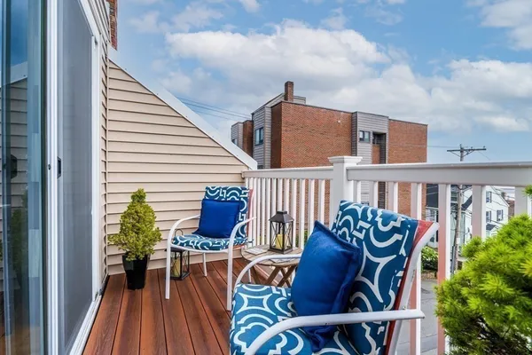 a view of a chairs and table on the balcony
