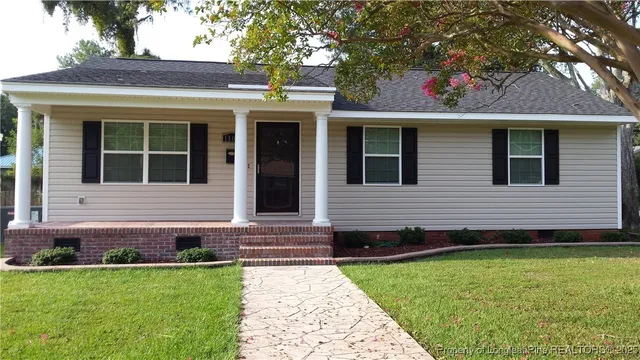a view of a house with a yard