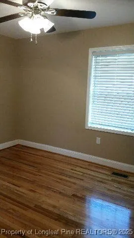 a view of a room with window and wooden floor