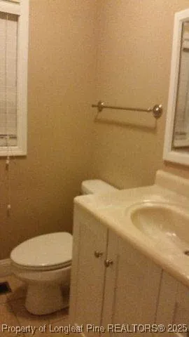a white toilet sitting next to a shower