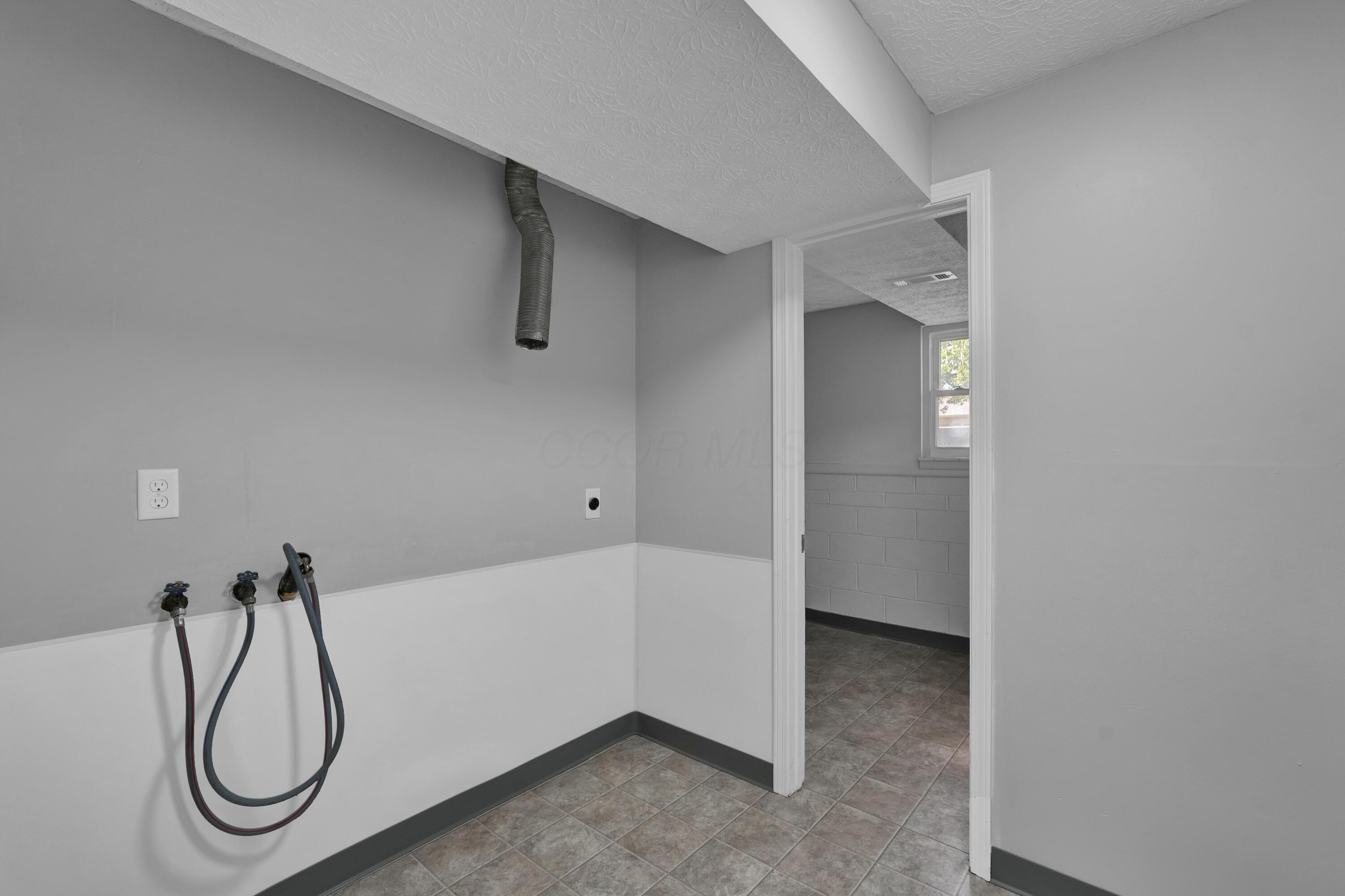 208 Cumberland Road Delaware, OH 43015 - Photo 26 of 37 Laundry room is freshly painted with new vinyl flooring and freshly painted space. If you must do laundry, do it in style!