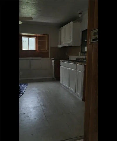 a view of an empty room with windows and closet