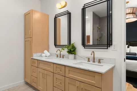 a bathroom with 2 sink and a mirror