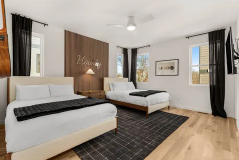 a spacious bedroom with a bed couch and a window