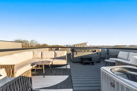 a terrace with outdoor seating and city view