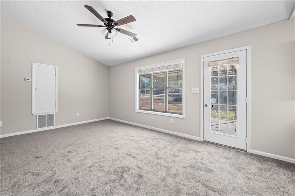 5345 Memorial Lane Southwest Powder Springs, GA 30127 - Photo 12 of 35 an empty room with windows and ceiling fan