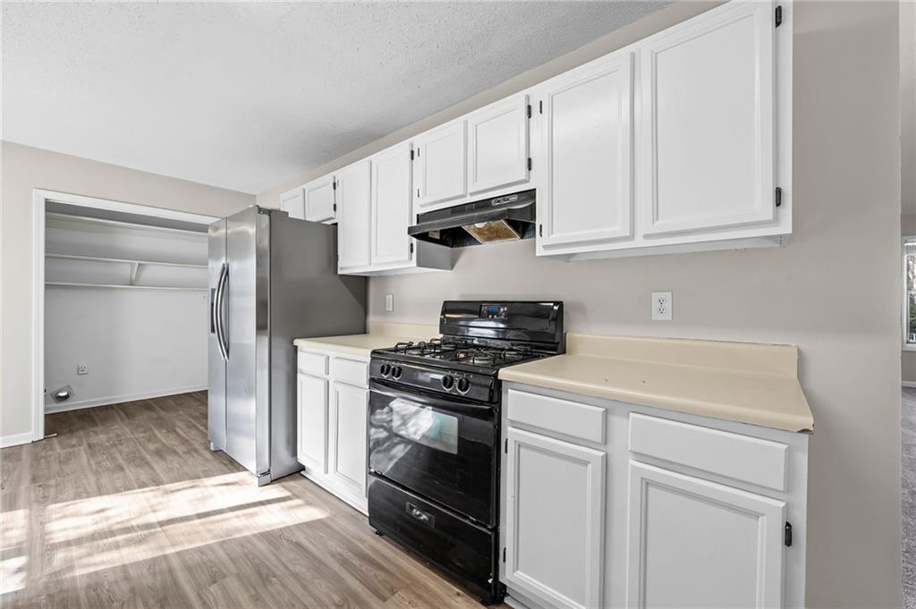 5345 Memorial Lane Southwest Powder Springs, GA 30127 - Photo 15 of 35 a kitchen with white cabinets and appliances