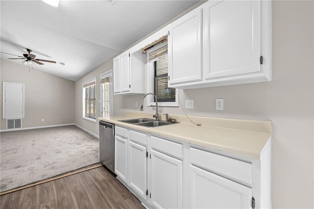 5345 Memorial Lane Southwest Powder Springs, GA 30127 - Photo 16 of 35 a kitchen with granite countertop white cabinets and white appliances