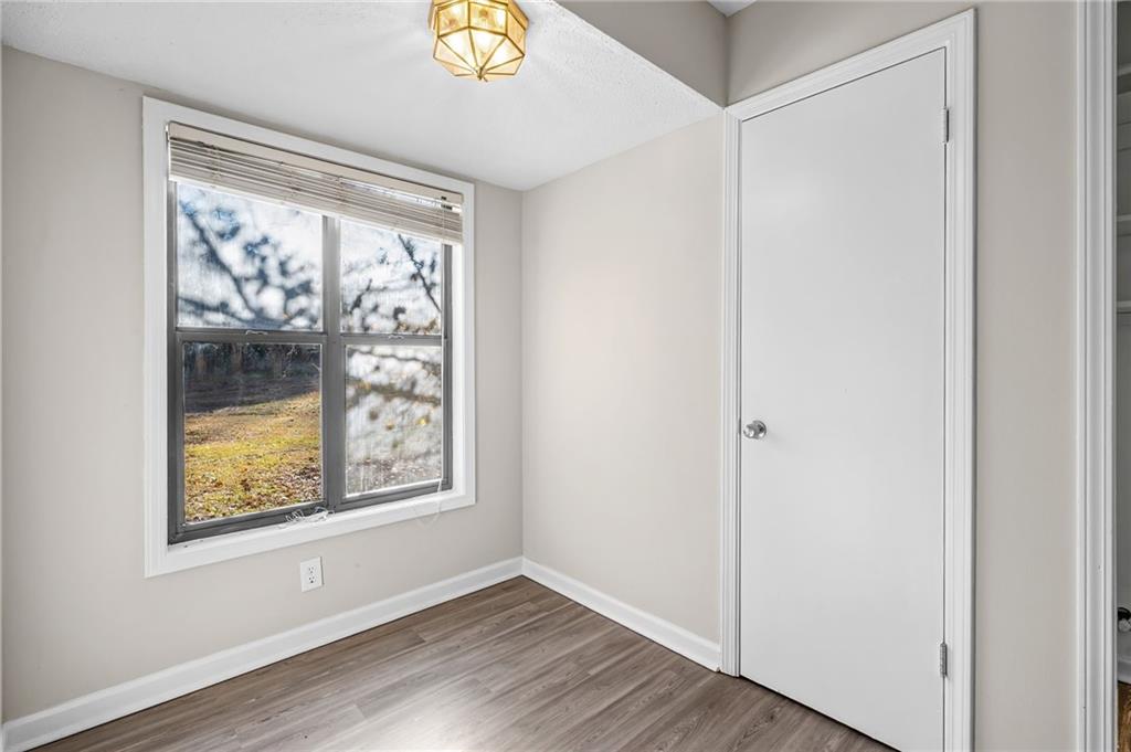 5345 Memorial Lane Southwest Powder Springs, GA 30127 - Photo 17 of 35 a view of an empty room with wooden floor and a window