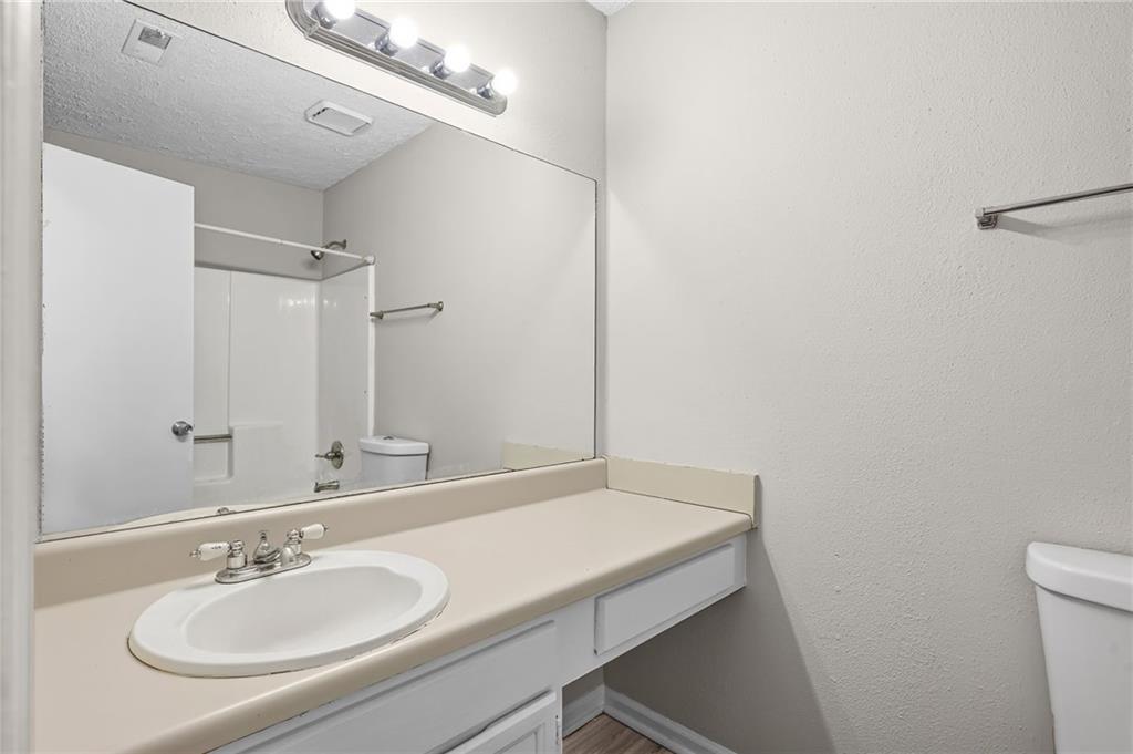 5345 Memorial Lane Southwest Powder Springs, GA 30127 - Photo 19 of 35 a bathroom with a sink a toilet and a mirror