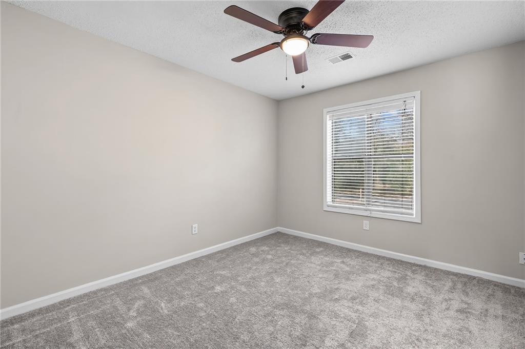 5345 Memorial Lane Southwest Powder Springs, GA 30127 - Photo 21 of 35 an empty room with a window and a fan