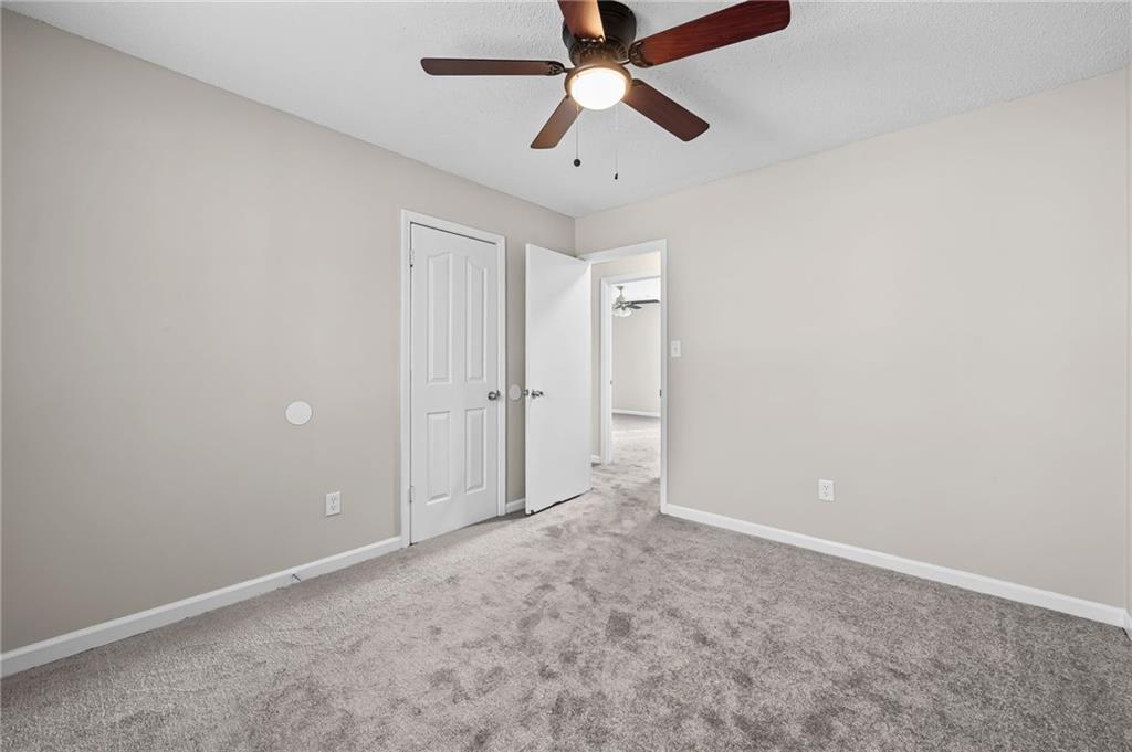 5345 Memorial Lane Southwest Powder Springs, GA 30127 - Photo 22 of 35 an empty room with chandelier fan