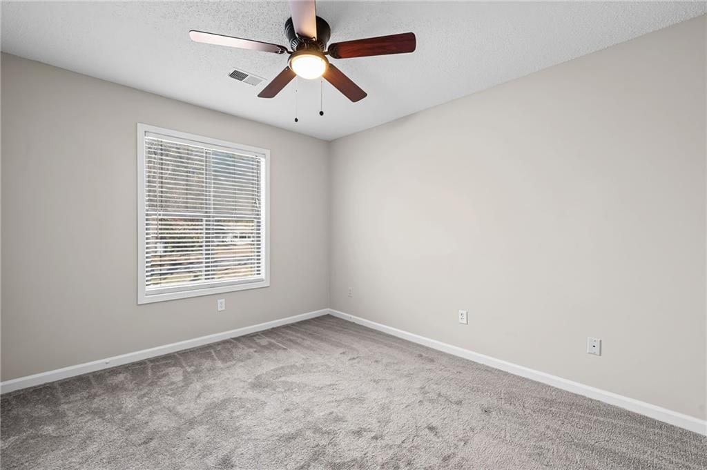 5345 Memorial Lane Southwest Powder Springs, GA 30127 - Photo 23 of 35 an empty room with a window and a fan