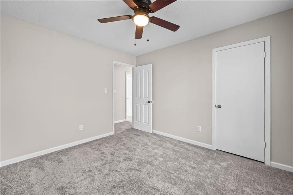 5345 Memorial Lane Southwest Powder Springs, GA 30127 - Photo 24 of 35 an empty room with closet and a chandelier fan