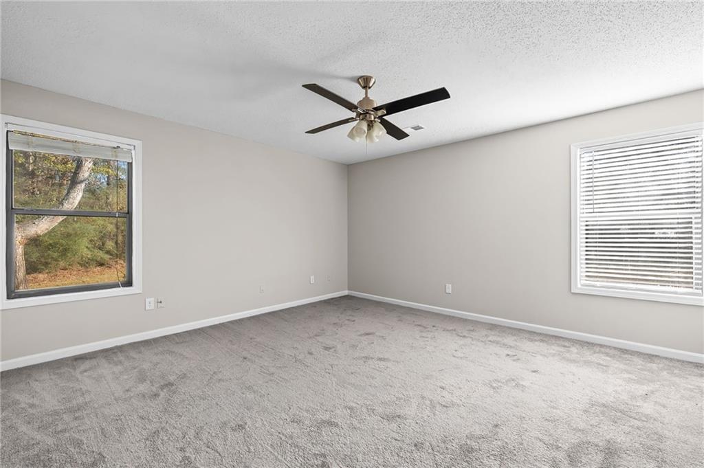 5345 Memorial Lane Southwest Powder Springs, GA 30127 - Photo 25 of 35 an empty room with a window and a fan