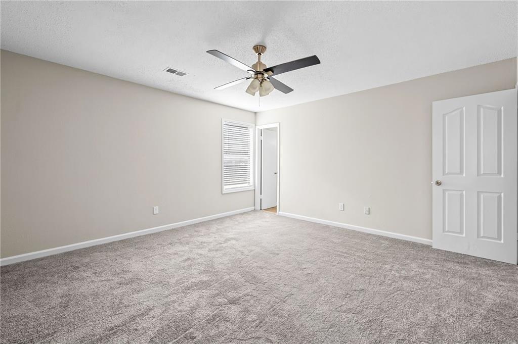 5345 Memorial Lane Southwest Powder Springs, GA 30127 - Photo 26 of 35 an empty room with windows and fan