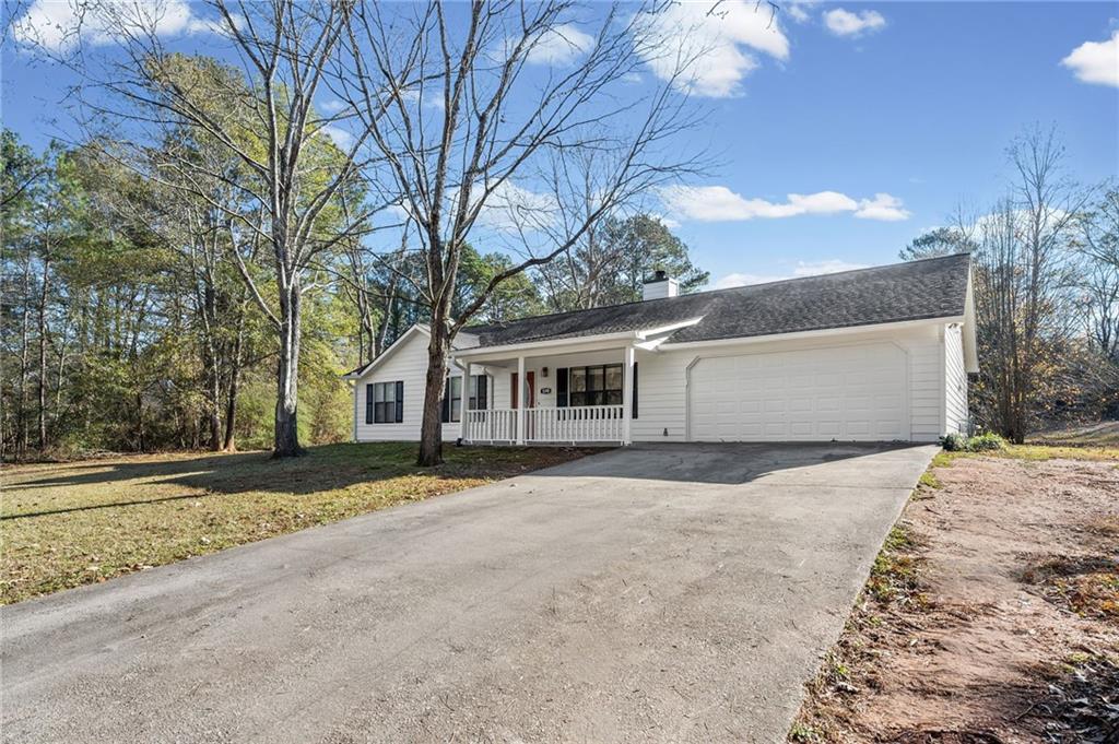 5345 Memorial Lane Southwest Powder Springs, GA 30127 - Photo 3 of 35 a front view of a house with a yard and garage