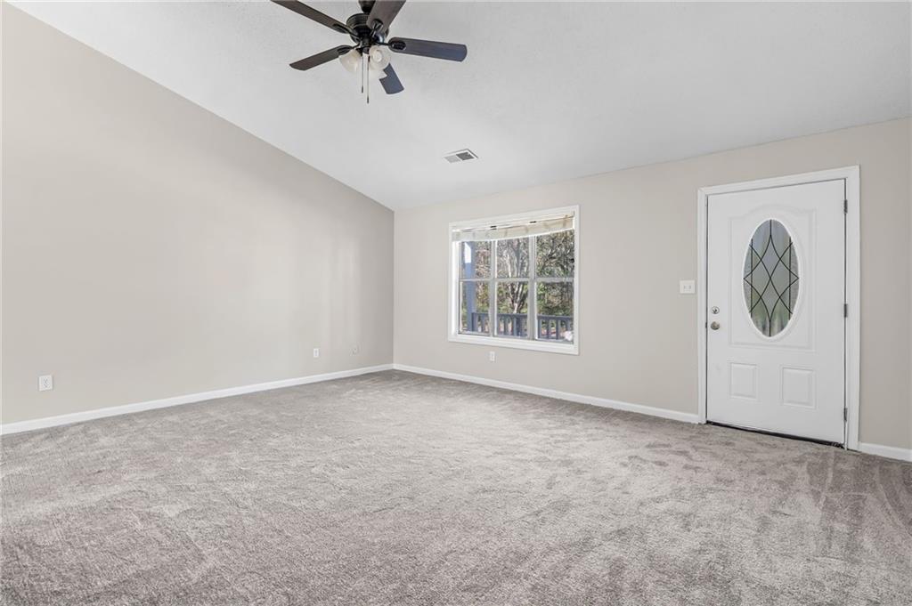 5345 Memorial Lane Southwest Powder Springs, GA 30127 - Photo 8 of 35 an empty room with windows and fan