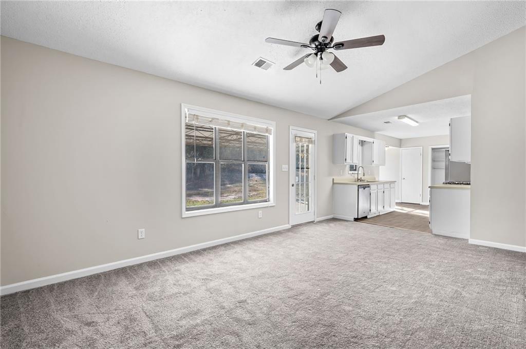 5345 Memorial Lane Southwest Powder Springs, GA 30127 - Photo 9 of 35 a view of a livingroom with a chandelier fan and windows