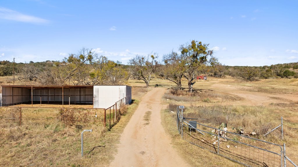 1101 Crider Road Marble Falls, TX 78654 - Photo 21 of 37 View of dirt / gravel road with a rural view and a pole building