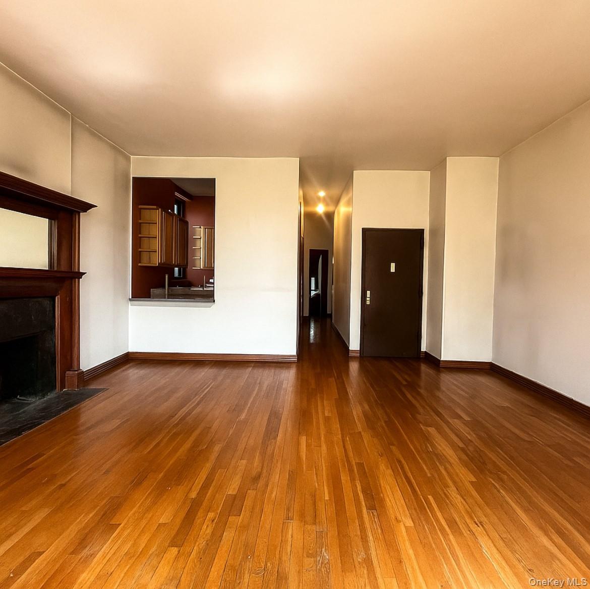 451 West 162nd Street, Unit 3 Manhattan, NY 10032 - Photo 3 of 12 a view of a room with wooden floor and a refrigerator