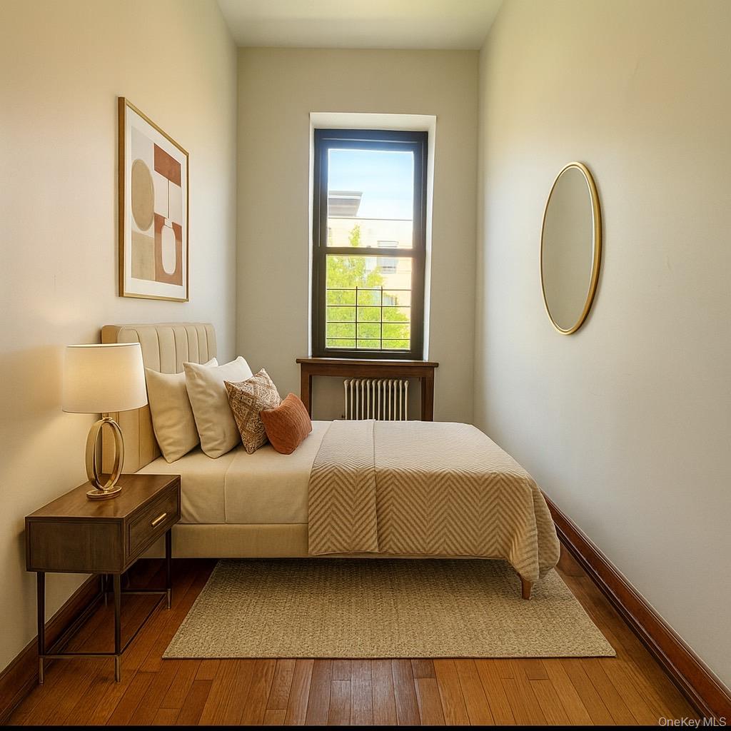 451 West 162nd Street, Unit 3 Manhattan, NY 10032 - Photo 10 of 12 a bedroom with a bed lamp and a window
