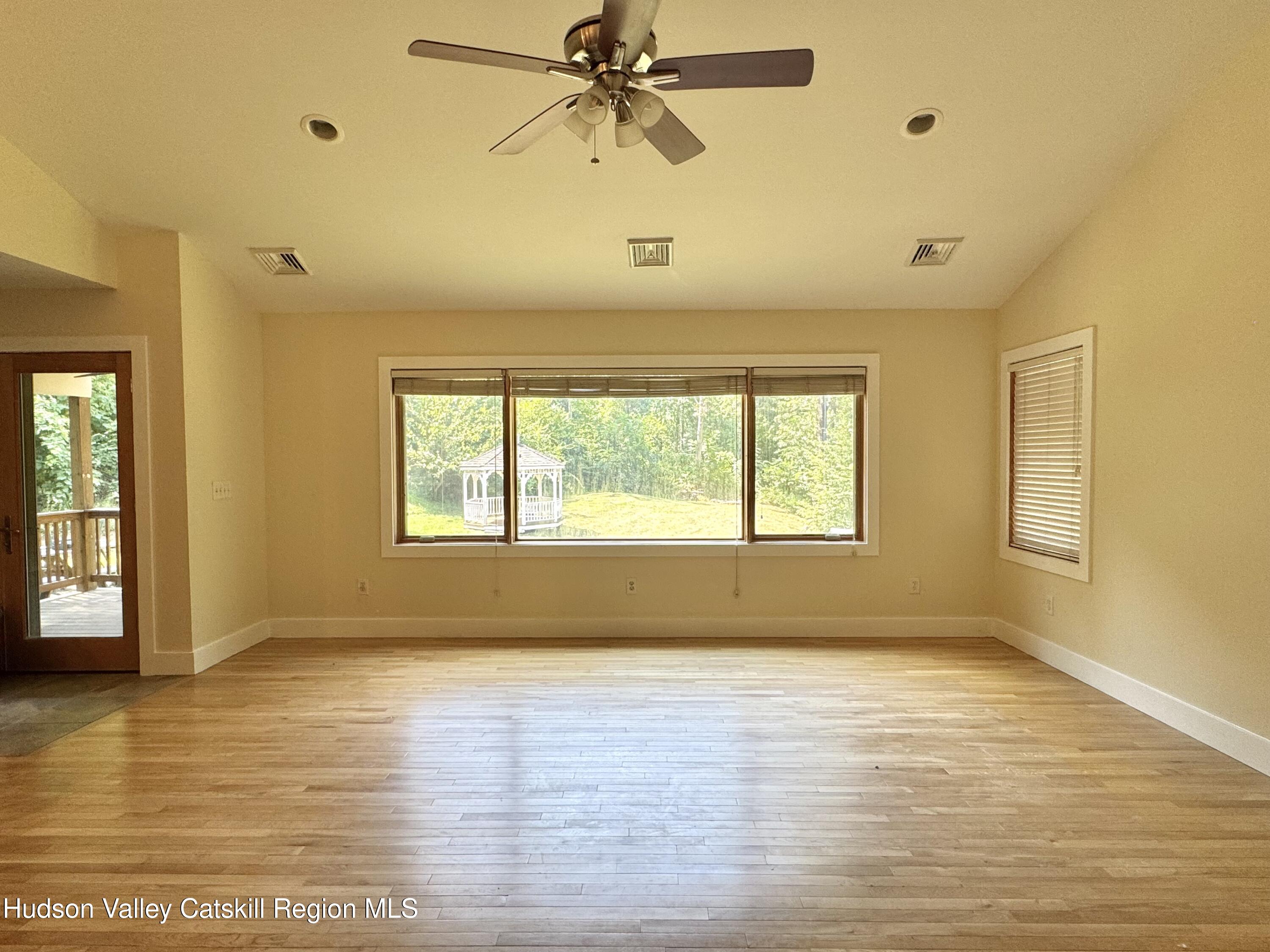 86 Paul Horn Road Catskill, NY 12414 - Photo 11 of 41 a view of an empty room with wooden floor and a window