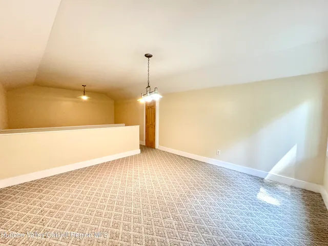 a living room with furniture a flat screen tv and next to a window