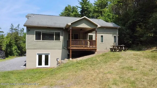 a kitchen with stainless steel appliances granite countertop a stove and a view of living room