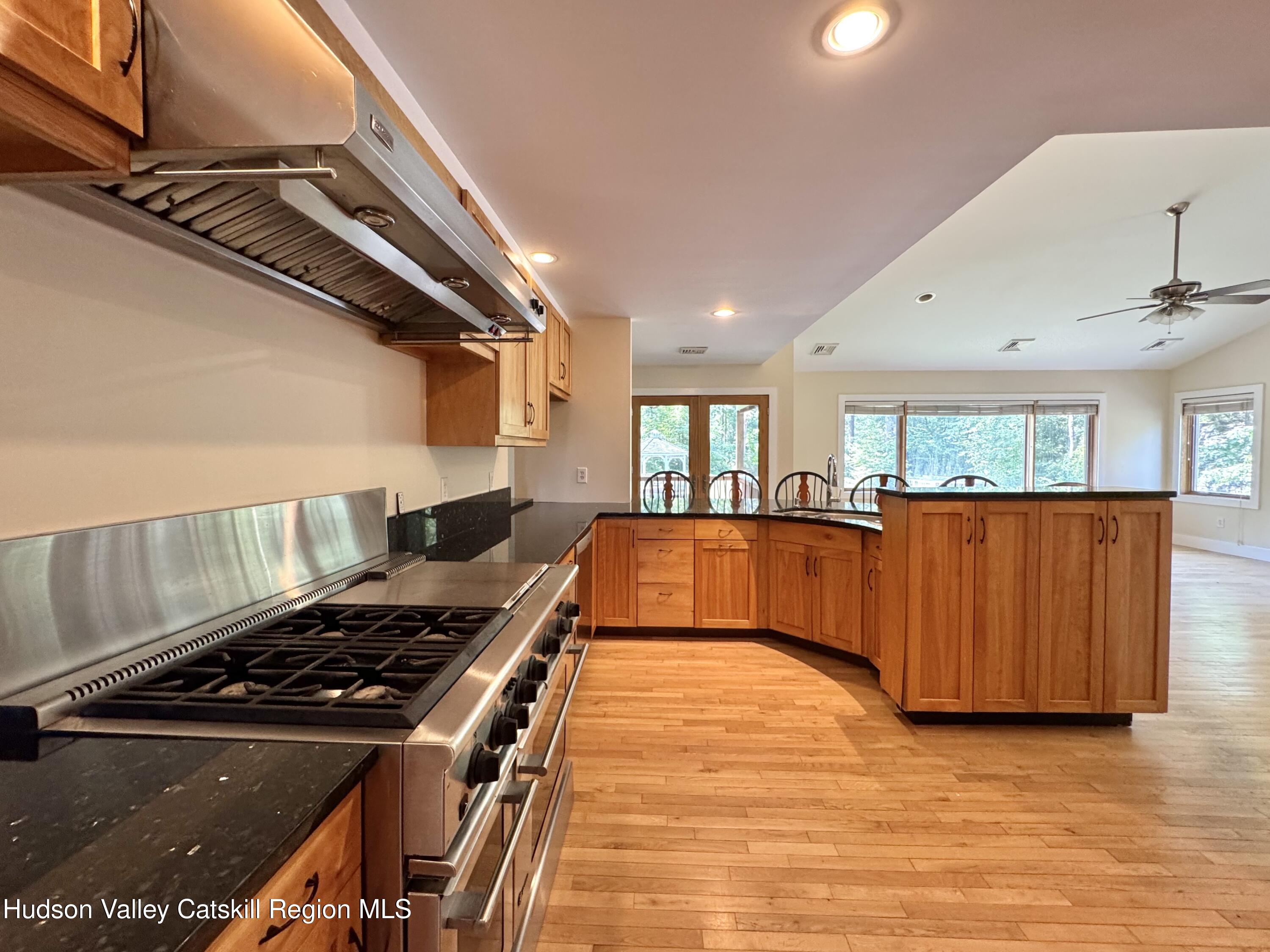 86 Paul Horn Road Catskill, NY 12414 - Photo 5 of 41 a kitchen with stainless steel appliances granite countertop a stove and a view of living room