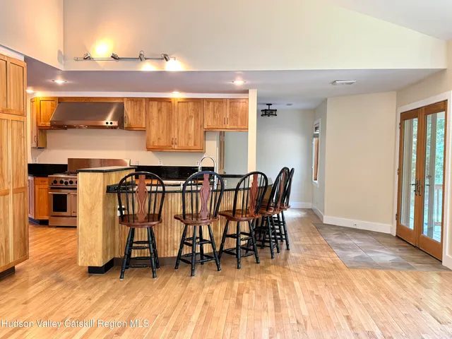 a view of a room with a ceiling fan and a rug